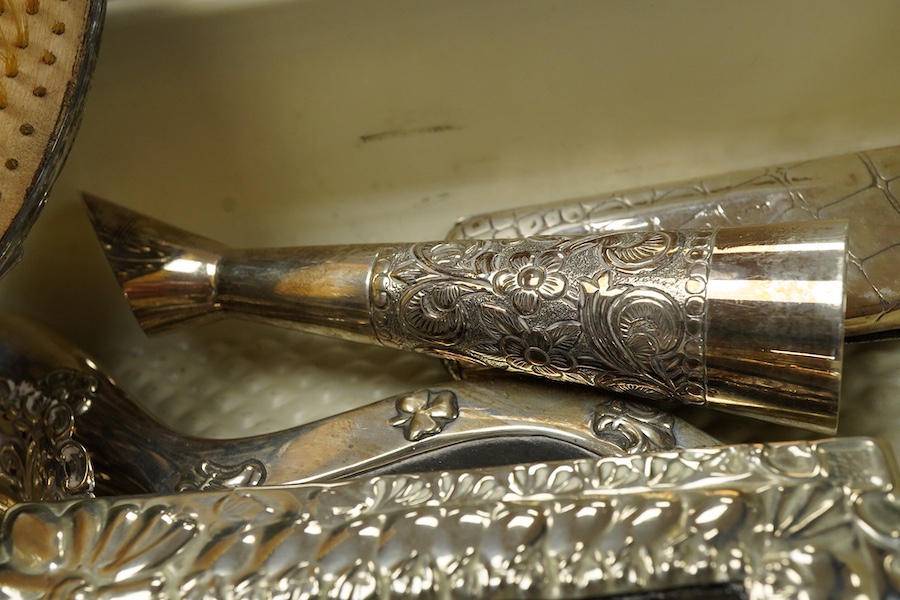 A small group of silver and white metal items, including an Edwardian silver and tortoiseshell mounted hand mirror by Samuel Jacob, 26.1cm, a silver mounted hair brush, a small silver mounted brush, a repousse silver pin
